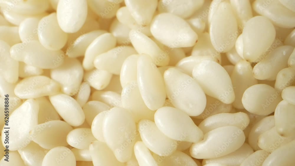 Mesmerizing macro video of white sesame seeds, showcasing intricate textures and patterns up close. Explore the tiny world of these nutritious wonders. White Sesame Seeds background
Mesmerizing macro video of white sesame seeds, showcasing intricate textures and patterns up close. Explore the tiny world of these nutritious wonders. White Sesame Seeds background