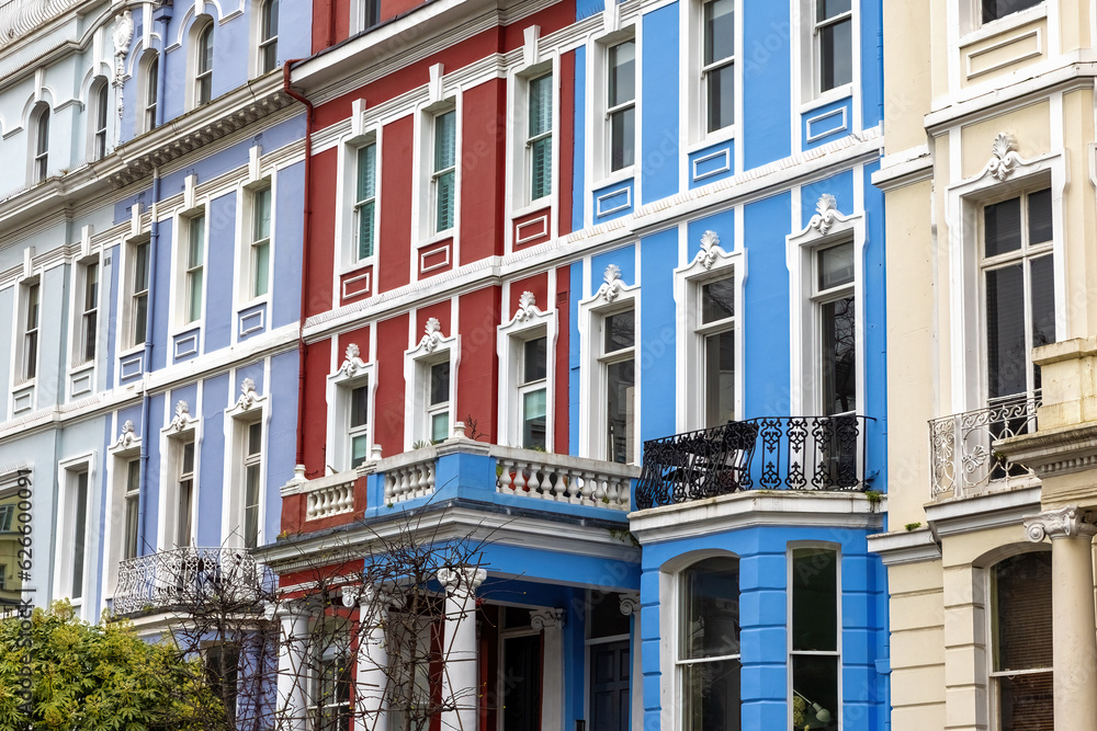 Obraz premium Detail of colourful terraced townhouses. The area of Notting Hill, London, is famous for streets of houses with brightly painted exteriors.