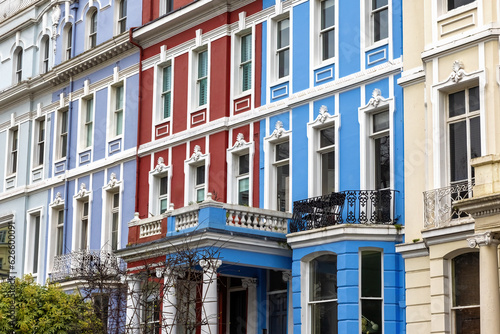 Detail of colourful terraced townhouses. The area of Notting Hill, London, is famous for streets of houses with brightly painted exteriors.