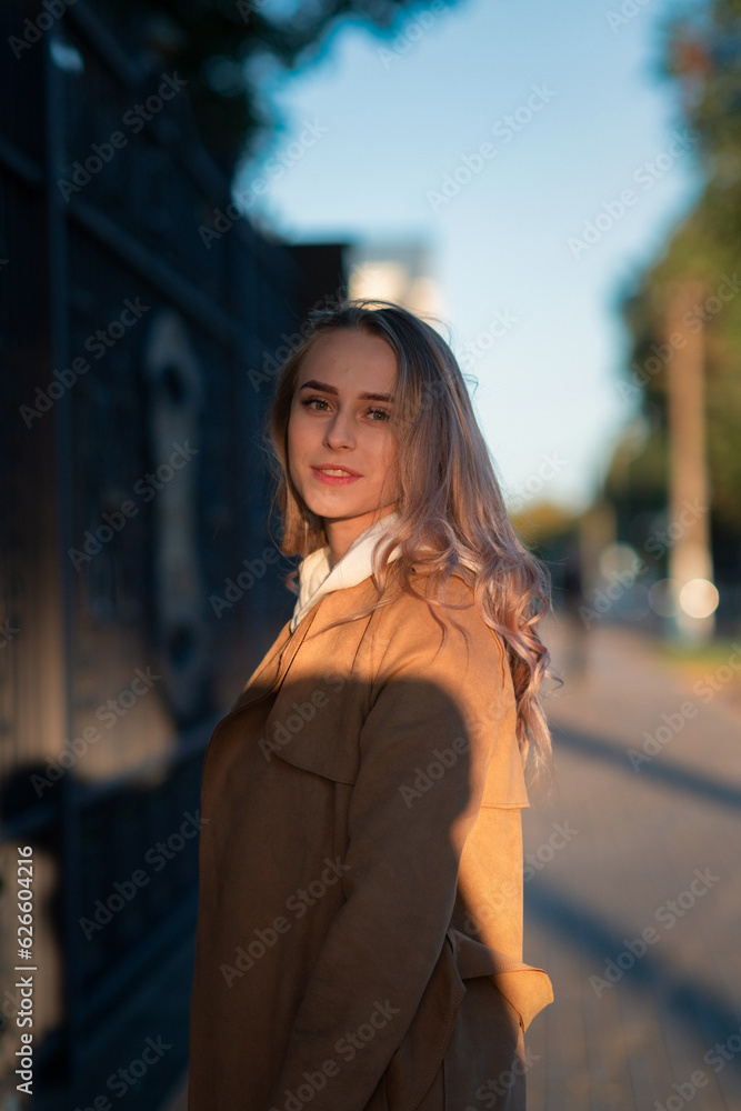 Portrait of a young beautiful fair-haired girl in the autumn park.
