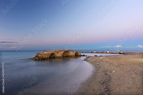 Beautiful beach of Argassi and the medieval Venetian stone bridge that is now completely within the sea, in Zakynthos island, Ionian Sea, Greece, Europe. 