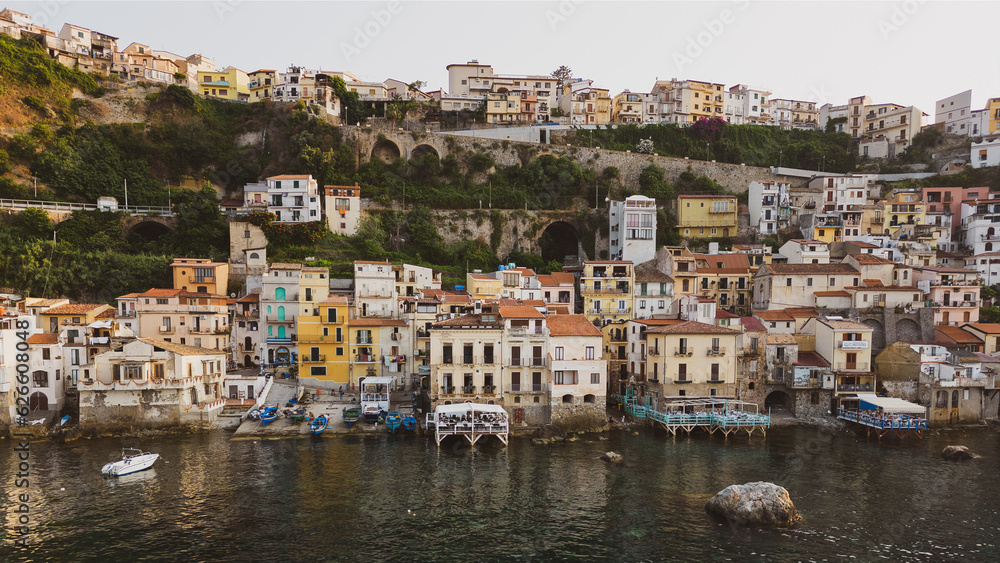 Italy, July 2023: aerial view from the drone of the medieval village of Scilla and Chianalea in Calabria, with its castle, tourist port and houses directly on the sea with its restaurants on stilts