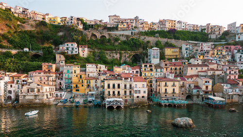 Italy, July 2023: aerial view from the drone of the medieval village of Scilla and Chianalea in Calabria, with its castle, tourist port and houses directly on the sea with its restaurants on stilts © cristian