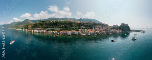 Italy, July 2023: aerial super panorama of the beautiful medieval village of Scilla and Chianalea in Calabria with the beautiful Castle and the crystal clear Caribbean sea