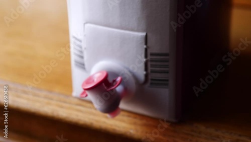 A bag of wine in a carton box. Bag-in-box or BiB is a container for the storage and transportation of liquids with tap. Strong bladder or plastic bag seated inside a corrugated fiberboard box