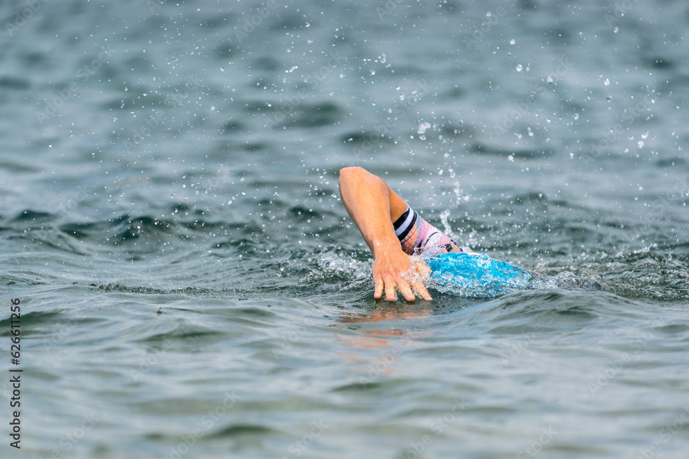 An athlete swimming in a lake 