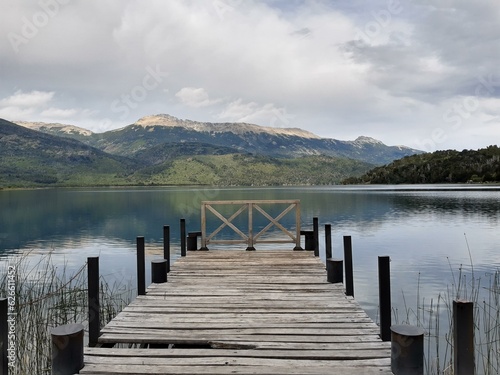 Wooden plank pier on the shore of a lake.
