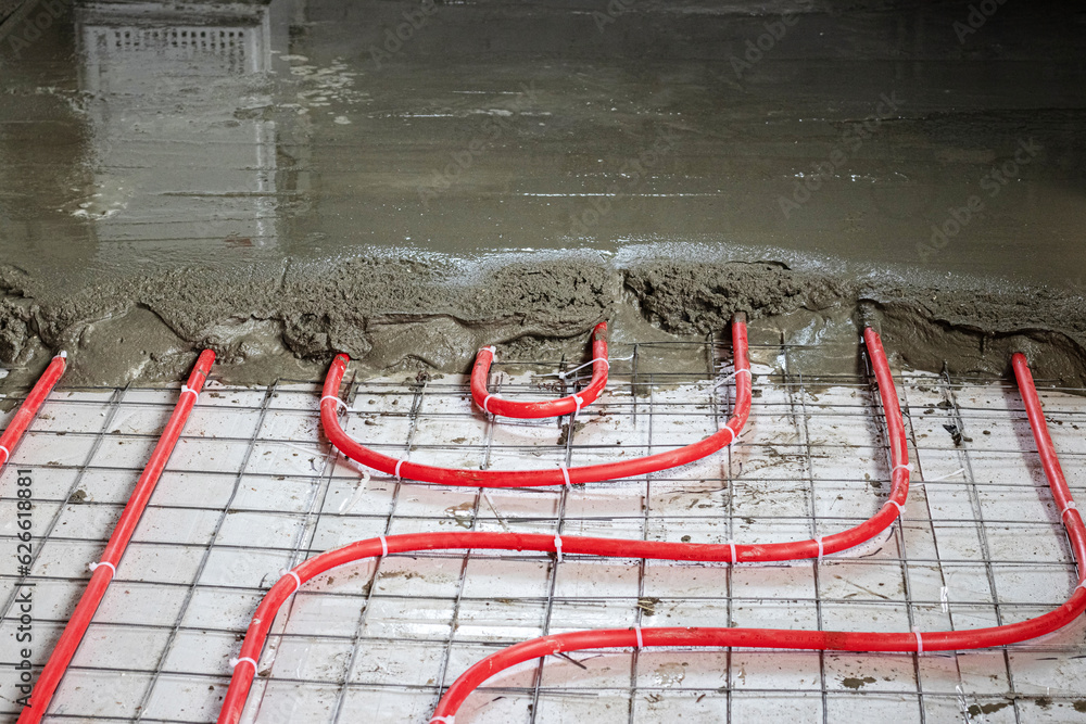 Installation of polypropylene pipes for underfloor heating systems, pouring  the floor with concrete Stock Photo | Adobe Stock