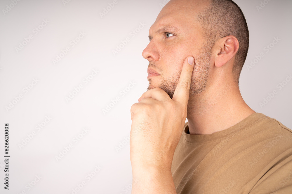 Man hold his chin with his hand and think about a solution and a good plan Man hold his chin with his hand and think about a solution and a good plan