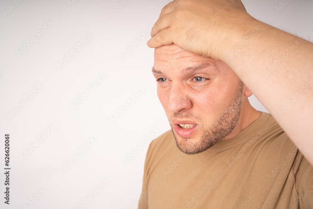 Obraz premium Man holds hand on his head because he did something wrong and has now problems 