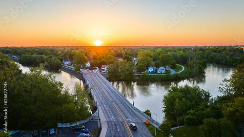 Horseshoe riverbend aerial small town with bridge over water at sunrise sunset landscape village
