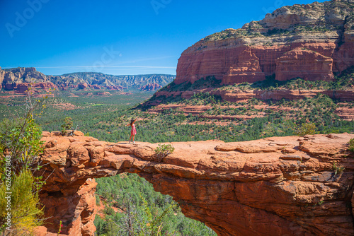 Travel in Devil's Bridge Trail, scenic view panoramic landscape in Sedona, Arizona, USA. Happy young woman on the famous trail in Sedona