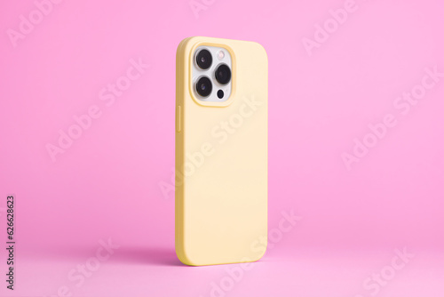 iPhone 15 Pro in yellow case back side view isolated on pink background, phone case mock up