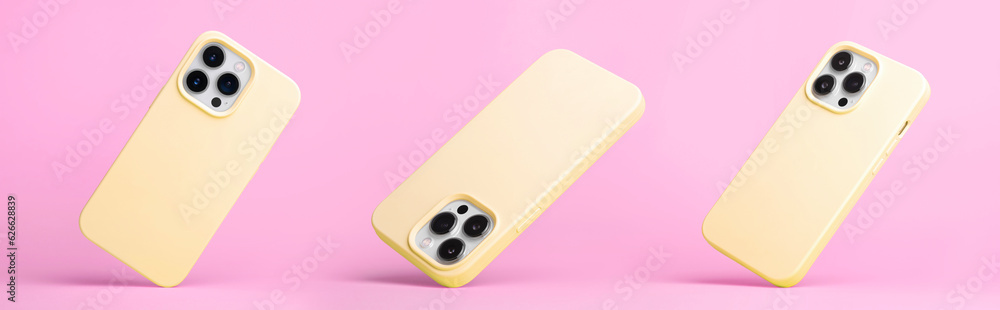set of three iPhone 15 pro in yellow silicone case falling down in different angles, back view isolated on pink background, phone case mockup