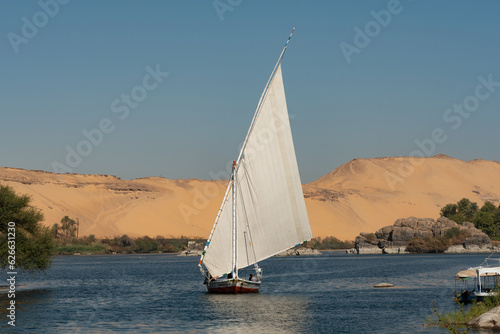 Beautiful landscape view of an Egyptian Felucca sail boat along the River Nile at Elephantine Island, A Nubian Village in Upper Egypt. .