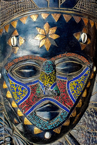 A close-up with an old African mask