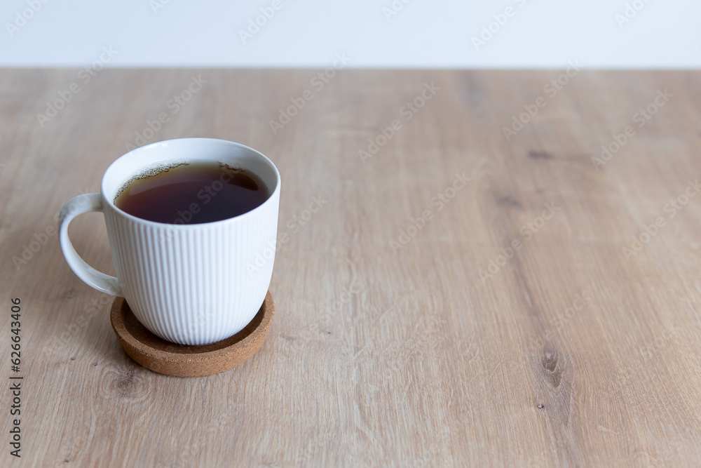 cup of coffee on wooden table close up cup of coffee on wooden table close up