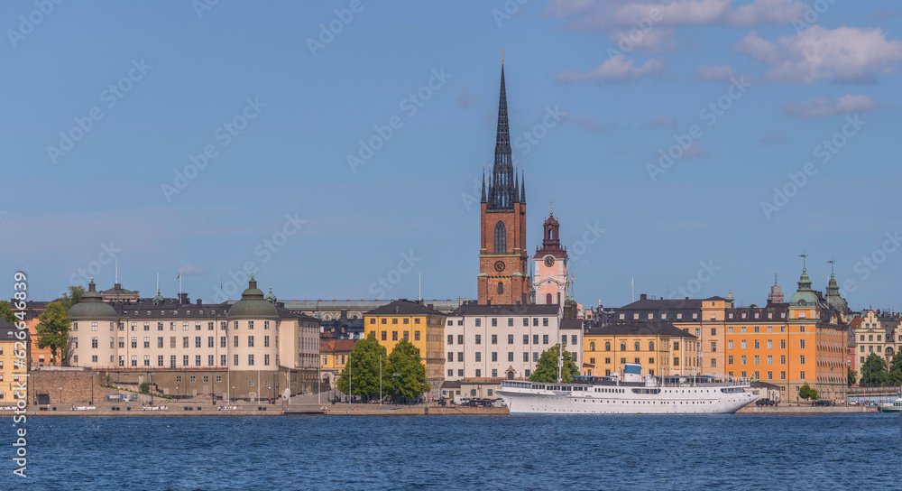 Old steel boat hotel at the pier Evert Taubes terass, court houses and churches in at the island Riddarholmen, a sunny summer day in Stockholm