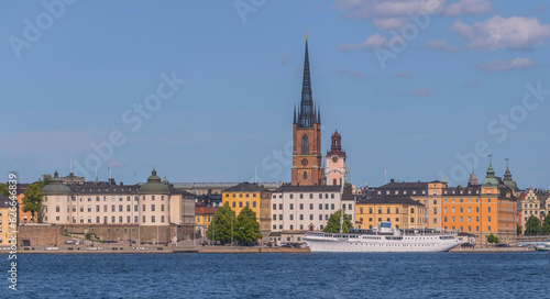 Old steel boat hotel at the pier Evert Taubes terass, court houses and churches in at the island Riddarholmen, a sunny summer day in Stockholm