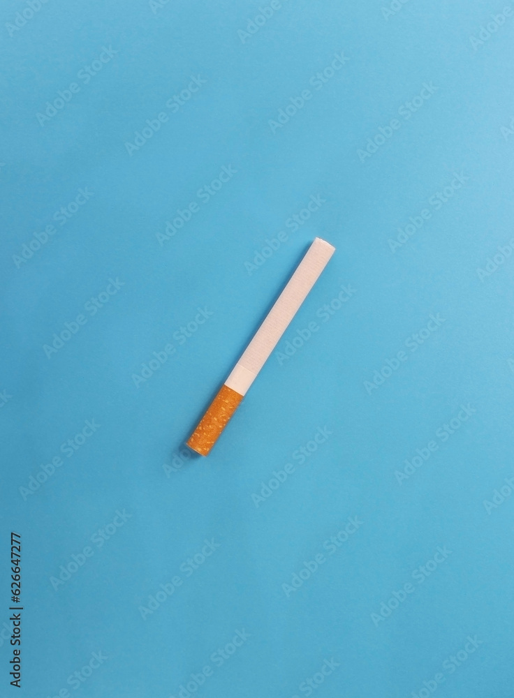 A cigarette on a blue background A cigarette on a blue background