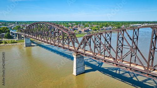 Aerial of brown or rusty red bridge over murky brown river water, Ohio River Louisville Kentucky