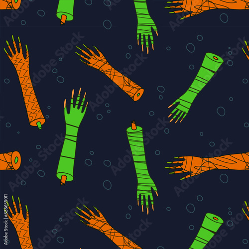 Halloween seamless pattern of textured green and orange zombie arms on dark blue background with bubbles; creepy comic surface design of cartoon monster hands with long nails