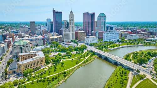 Drone view downtown Columbus Ohio over Scioto River with bridge and distant skyscrapers