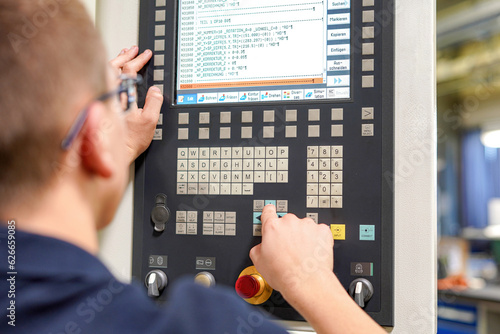The CNC milling machine programmer makes adjustments to the program to change the cutting parameters.