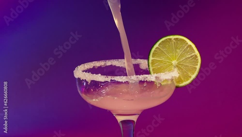 barbie cocktail. barbie core. Professional barman decorates a blue cocktail with ice . Bartender prepares cocktails on defocused background and pours and serves a cocktail . Barman preparing colorful
