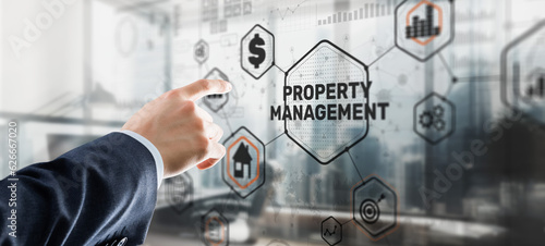 Businessman pressing PROPERTY MANAGEMENT button on virtual screens