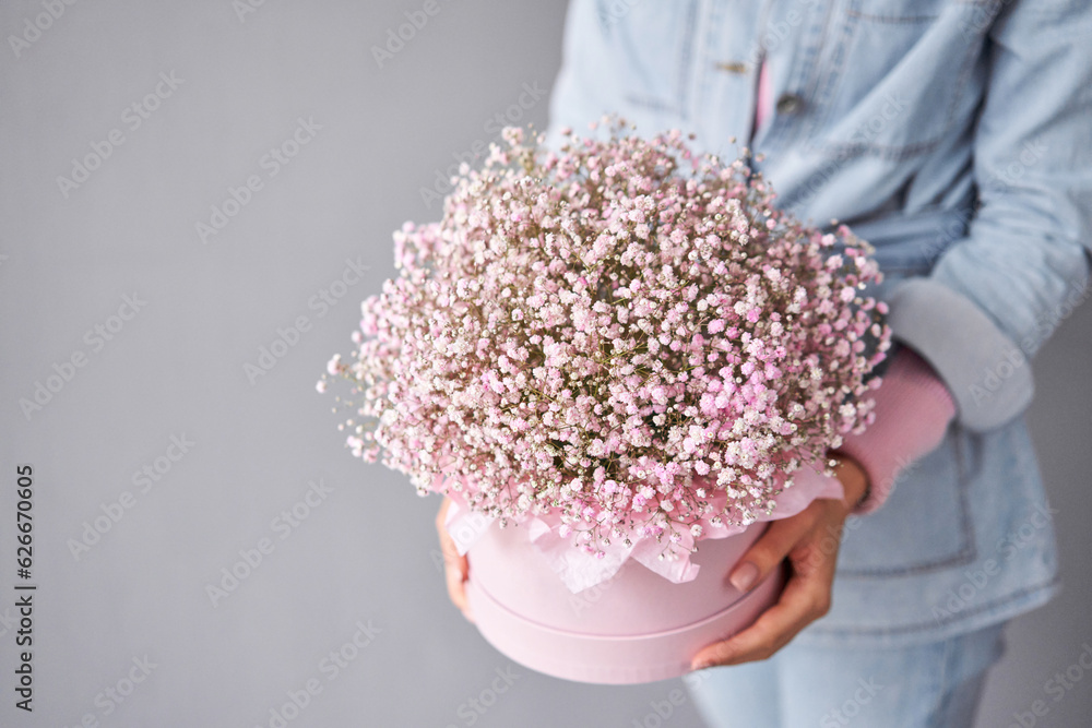 Gypsophila in a round hatbox. Beautiful bouquet of mixed flowers in ...