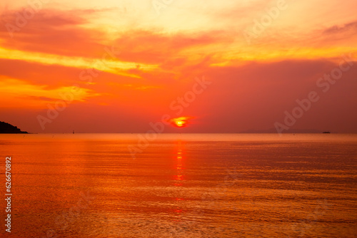 Orange sunset on the sea. The sun sets on the horizon. Travel and tourism.