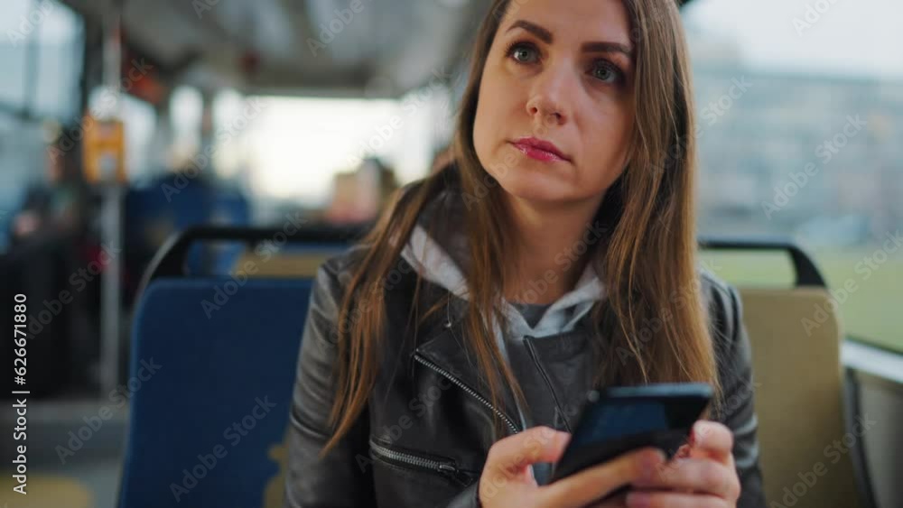 Public transport. Woman in tram using smartphone, slow motion Public transport. Woman in tram using smartphone, slow motion
