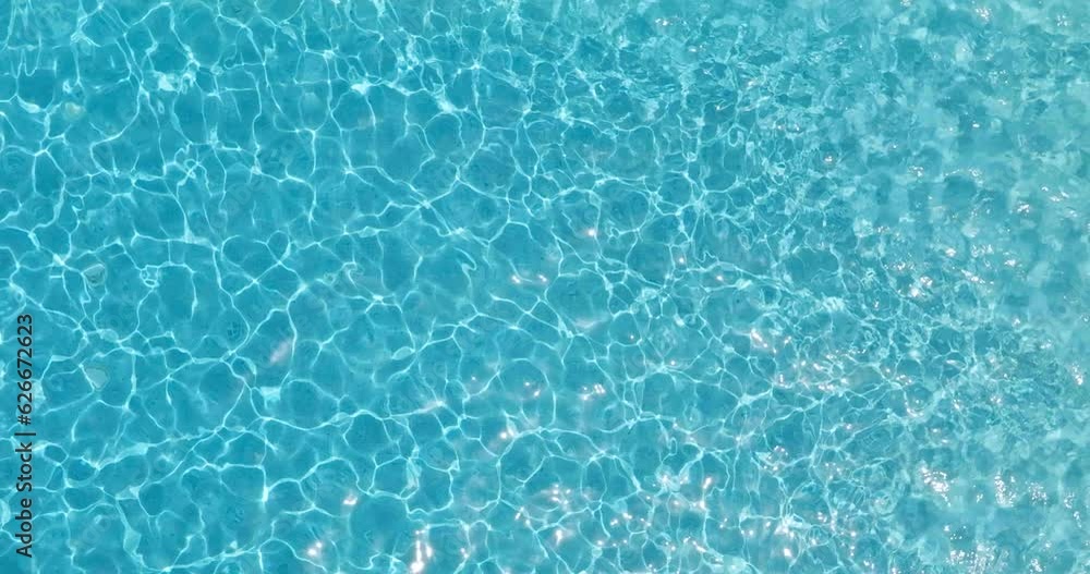 Blue water in the swimming pool with light reflections. Blue water in the swimming pool with light reflections.