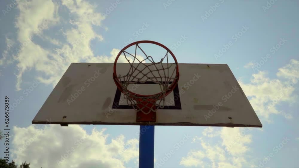 Basketball hoop and sun, slow motion Basketball hoop and sun, slow motion
