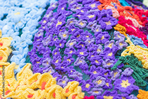 Beautiful colourful wool textile handmade flowers in a textured background still © jordieasy