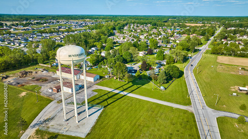 Aerial white Huntertown water tower on summer day with distant neighborhoods photo