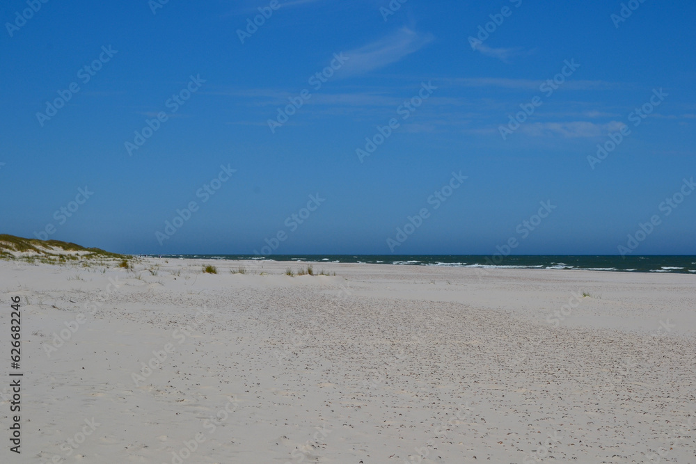 Baltic Sea coast and wild beach next to moving dunes in the Slovincian National Park also known as Slowinski National Park. Leba, Poland Baltic Sea coast and wild beach next to moving dunes in the Slovincian National Park also known as Slowinski National Park. Leba, Poland