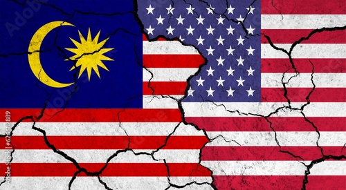 Flags of Malaysia and USA on cracked surface - politics, relationship concept