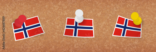 Norway flag pinned in cork board, three versions of Norway flag.