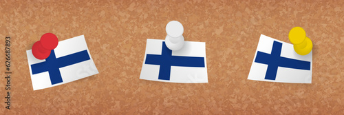 Finland flag pinned in cork board, three versions of Finland flag.