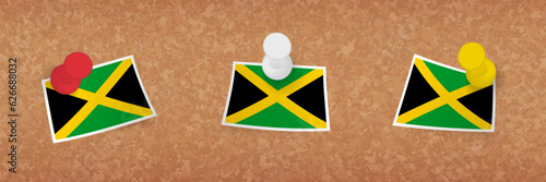 Jamaica flag pinned in cork board, three versions of Jamaica flag.