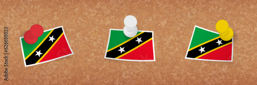 Saint Kitts and Nevis flag pinned in cork board, three versions of Saint Kitts and Nevis flag.