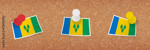 Saint Vincent and the Grenadines flag pinned in cork board, three versions of Saint Vincent and the Grenadines flag.