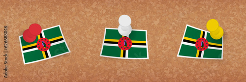 Dominica flag pinned in cork board, three versions of Dominica flag.