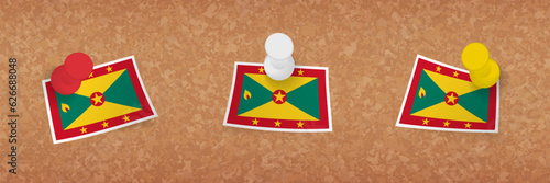 Grenada flag pinned in cork board, three versions of Grenada flag.