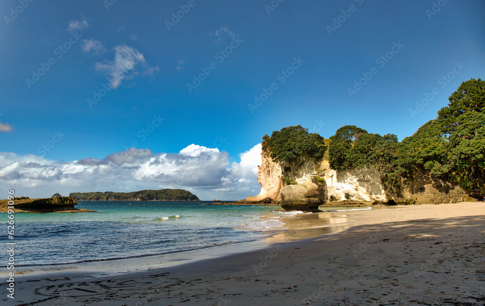 The golden beach and stunning  rock formations and archway  at Cathedral cove in the Coromandel NZ