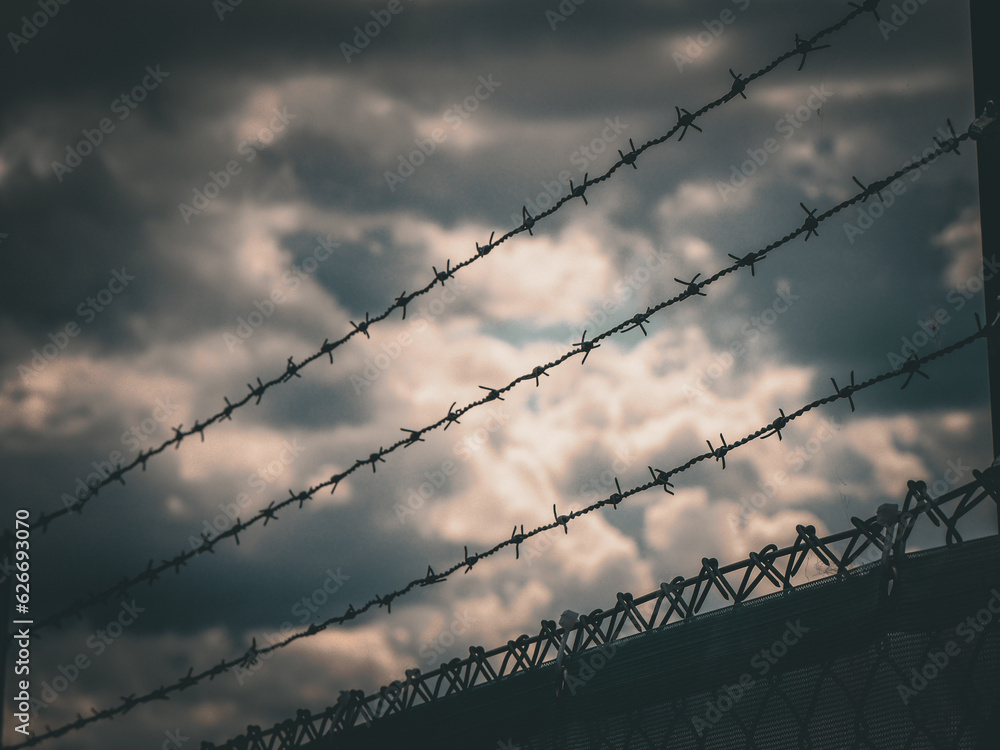 Close up of barbed wire against the sky