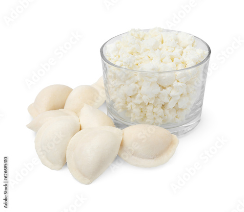 Raw dumplings  varenyky  and bowl with cottage cheese on white background
