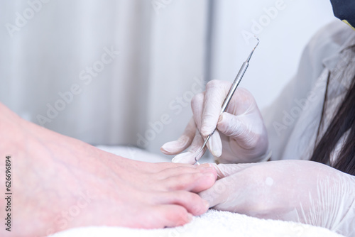 person doing manicure of man s feet